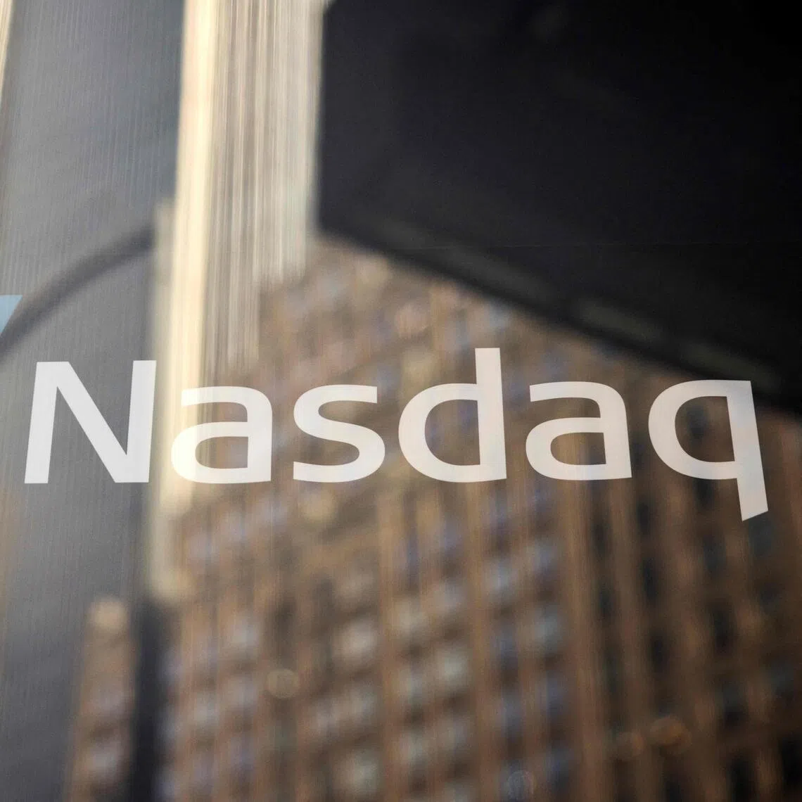(FILES) This photograph shows the logo of Nasdaq headquarters in Times Square in New York City on January 30, 2025. The EU on November 6, 2025 announced a formal antitrust probe against stock exchange operators Nasdaq and Deutsche Boerse over "possible collusion" involving financial derivatives. (Photo by Yuki IWAMURA / AFP)