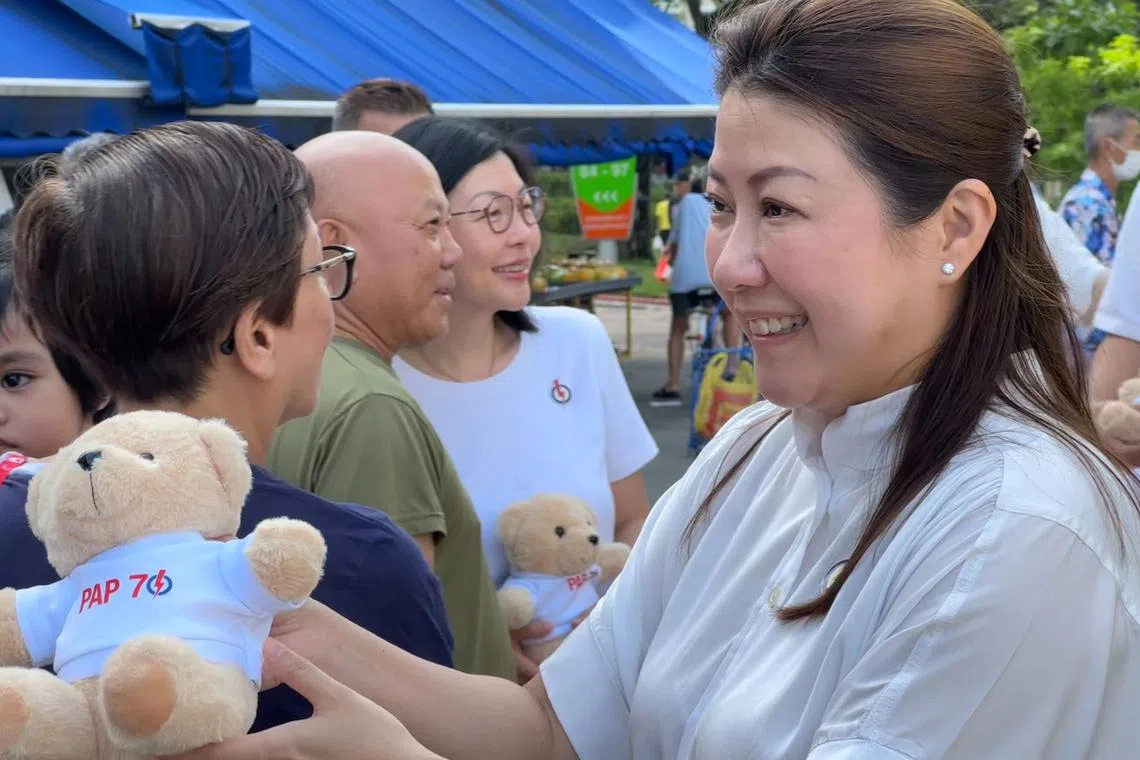 Wah & Hua CEO Melissa Tan (right) giving out PAP70 teddy bears at Bedok 85 Market with East Coast GRC MP Cheryl Chan (centre, in white) on Nov 17.