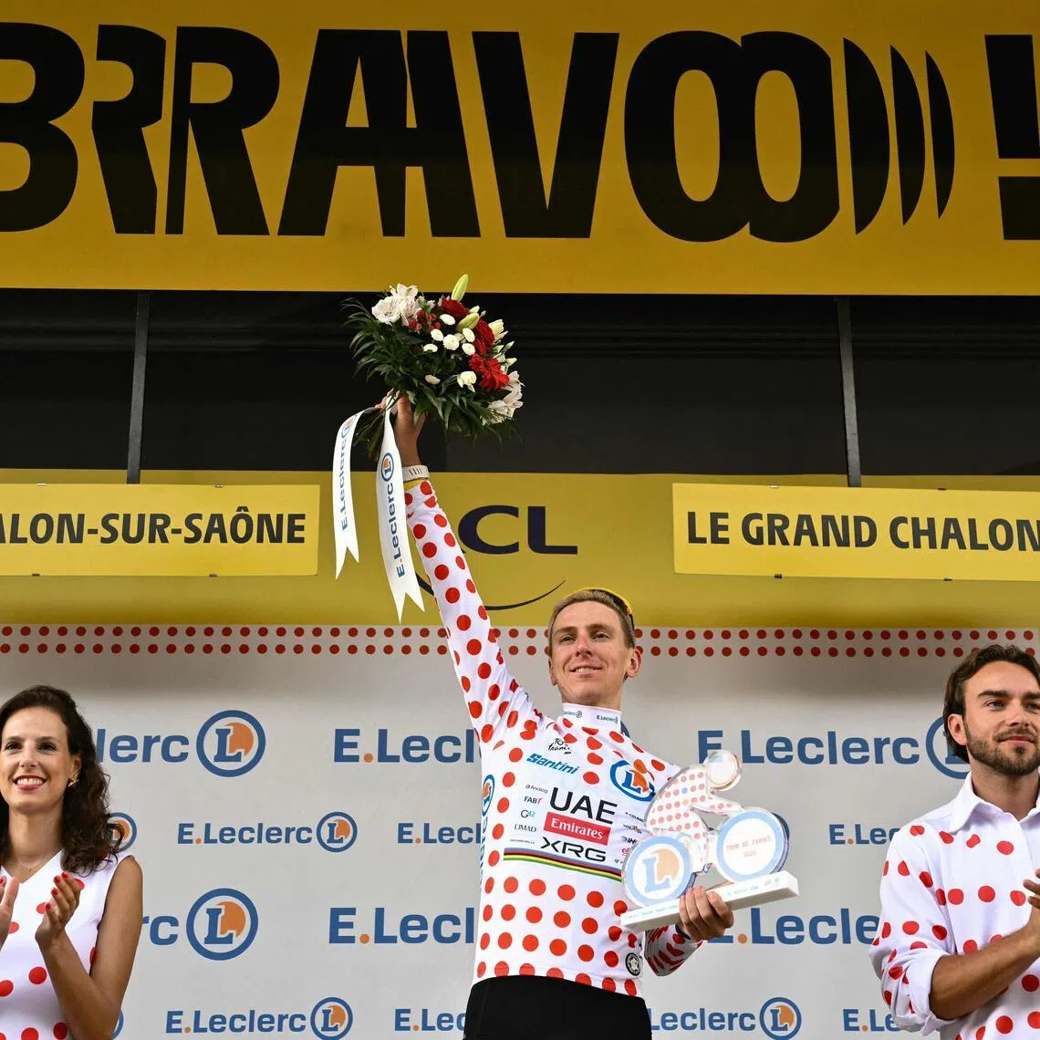 Slovenian rider Tadej Pogacar celebrates on the podium with the best climber’s polka-dot jersey after the 12th stage of the Tour de France.