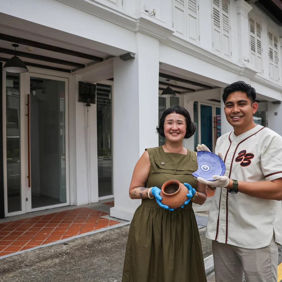 ST20251006_202535800676: Gin Tay/ kgarch10/ Ng Keng Gene/
***Embargoed till 10am on 10 Oct 2025***
(From left): Portraits of Natalie Tan, 44, Centre Manager of ArCH Square, HeritageSG; and Zinnurain Nasir, 33, Assistant Centre Manager of ArCH Square, HeritageSG; posing with the artefacts at centre's new space at 125 Jalan Sultan on Oct 6, 2025.
//Story on new HeritageSG's new education and outreach centre for archaeology and intangible cultural heritage called ArCH Square.