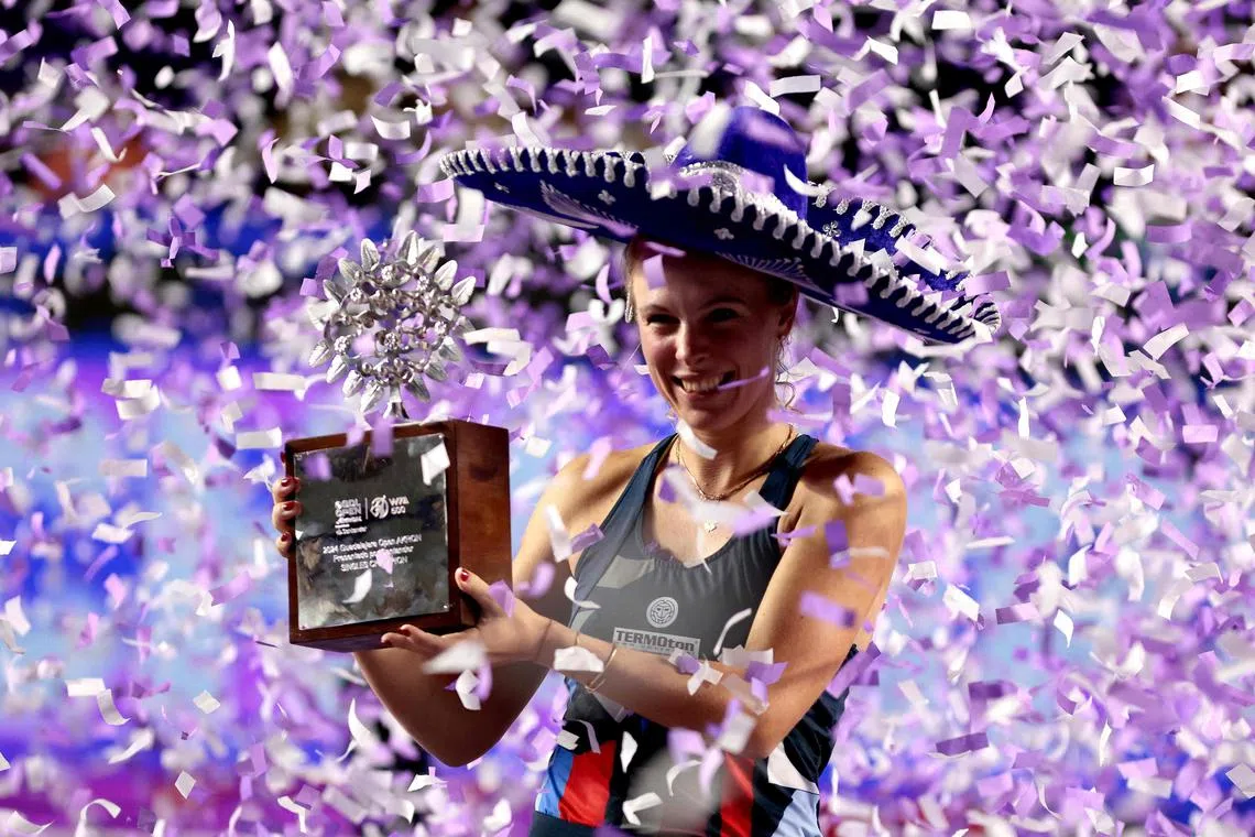 Poland's Magdalena Frech celebrating with her trophy on the podium after winning the women's singles final of the WTA Guadalajara Open tennis tournament in Zapopan, Mexico on September 15, 2024. 