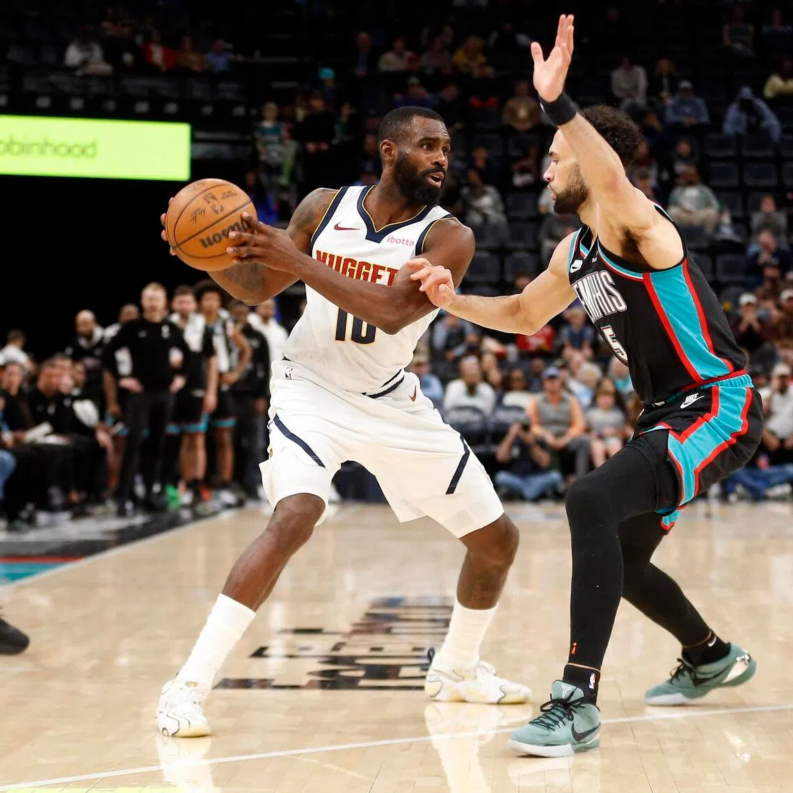 Denver Nuggets guard Tim Hardaway Jr. handles the ball as Memphis Grizzlies forward Tyler Burton defends during the fourth quarter at FedExForum.