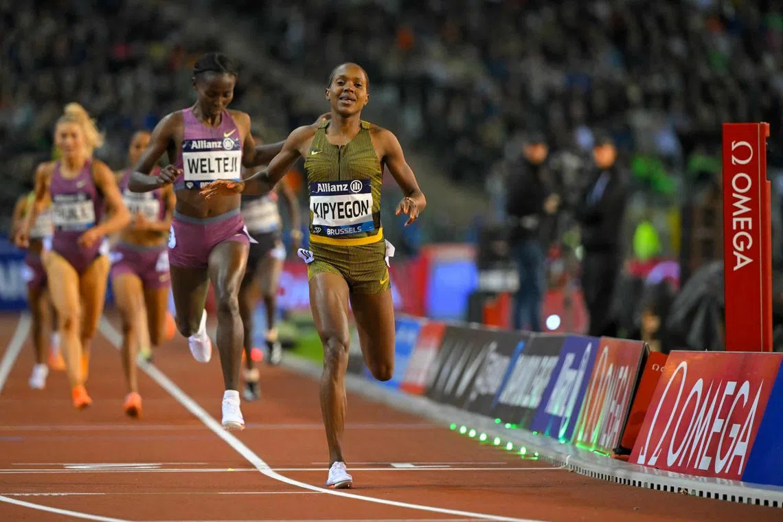 Kenya's Faith Kipyegon celebrates as she crosses the finish line to win the 1,500m final of the Diamond League meeting in Brussels.