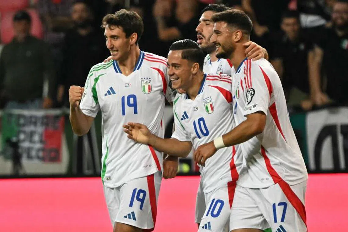 Italy's forward #10 Giacomo Raspadori (second from left) celebrates after scoring the 2-4 goal.