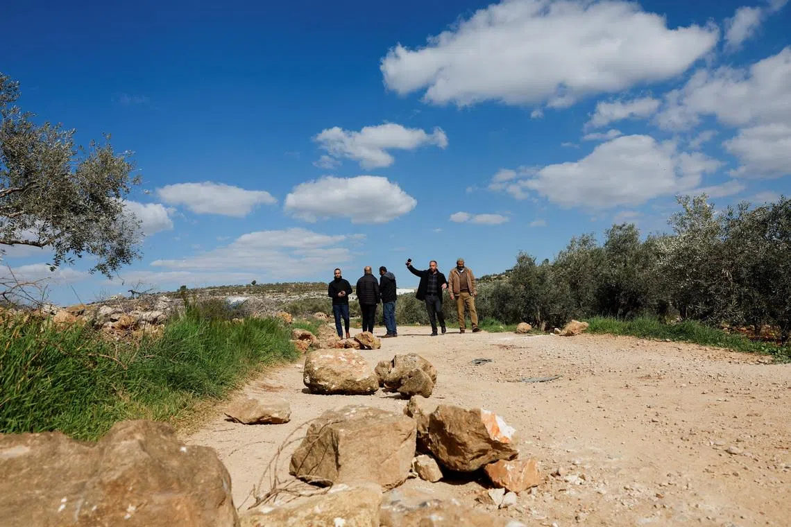 Palestinians stand near bloodstains at the site where Thaer Hamayel was killed during an attack by Israeli settlers on the Palestinians in the village of Abu Falah near Ramallah, in the Israeli-occupied West Bank, March 9, 2026. REUTERS/Ammar Awad