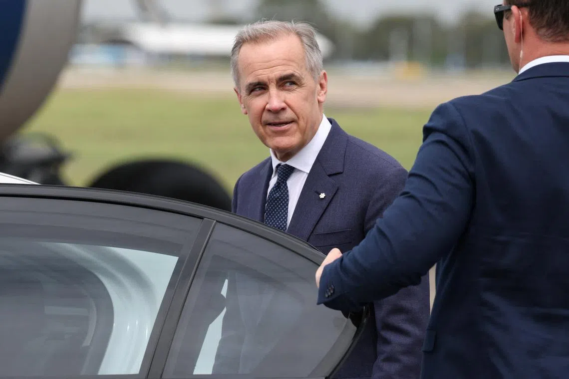 Canadian Prime Minister Mark Carney reacts as he enters a vehicle at Sydney Kingsford Smith Airport in Sydney, Australia, March 3, 2026. REUTERS/Hollie Adams