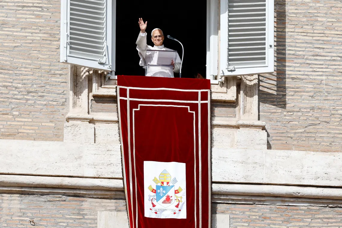 Pope Leo waved and smiled to the crowds after reaching the window unaided.
