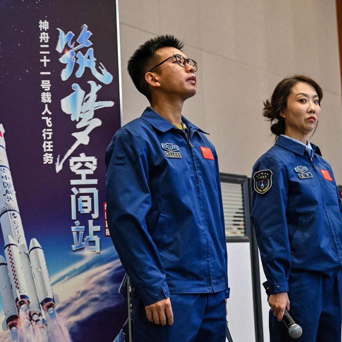 China's space agency staff at a press conference for the Shenzhou-21 Manned Space Mission one day before the mission's launch.f
