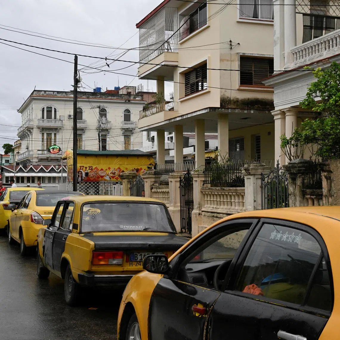 Taxi drivers wait in line for fuel outside a gas station, after U.S. President Donald Trump vowed to stop Venezuelan oil and money from reaching the island as Cubans brace for worsening fuel shortages amid regular power outages, in Havana, Cuba January 12, 2026. REUTERS/Norlys Perez