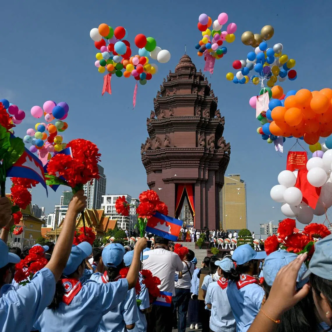 Cambodian students holding up flowers as balloons are released at the Independence Monument, during a ceremony marking Cambodia's 72nd Independence Day, in Phnom Penh on Nov 9, 2025. 