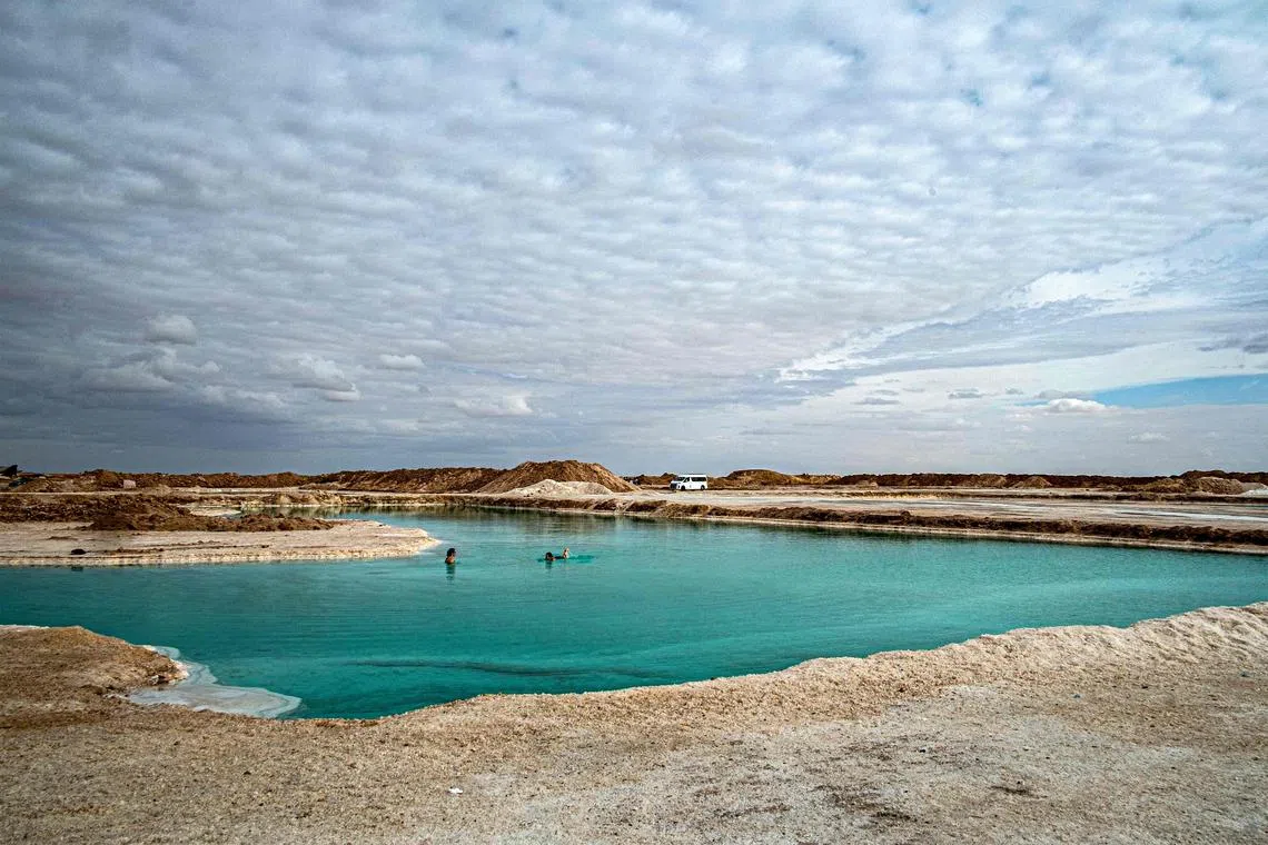 People wade in the Siwa salt lake in Egypt's western desert oasis of Siwa, about 55 kilometres east of the Libyan border and about 750 kilometres west of the capital.