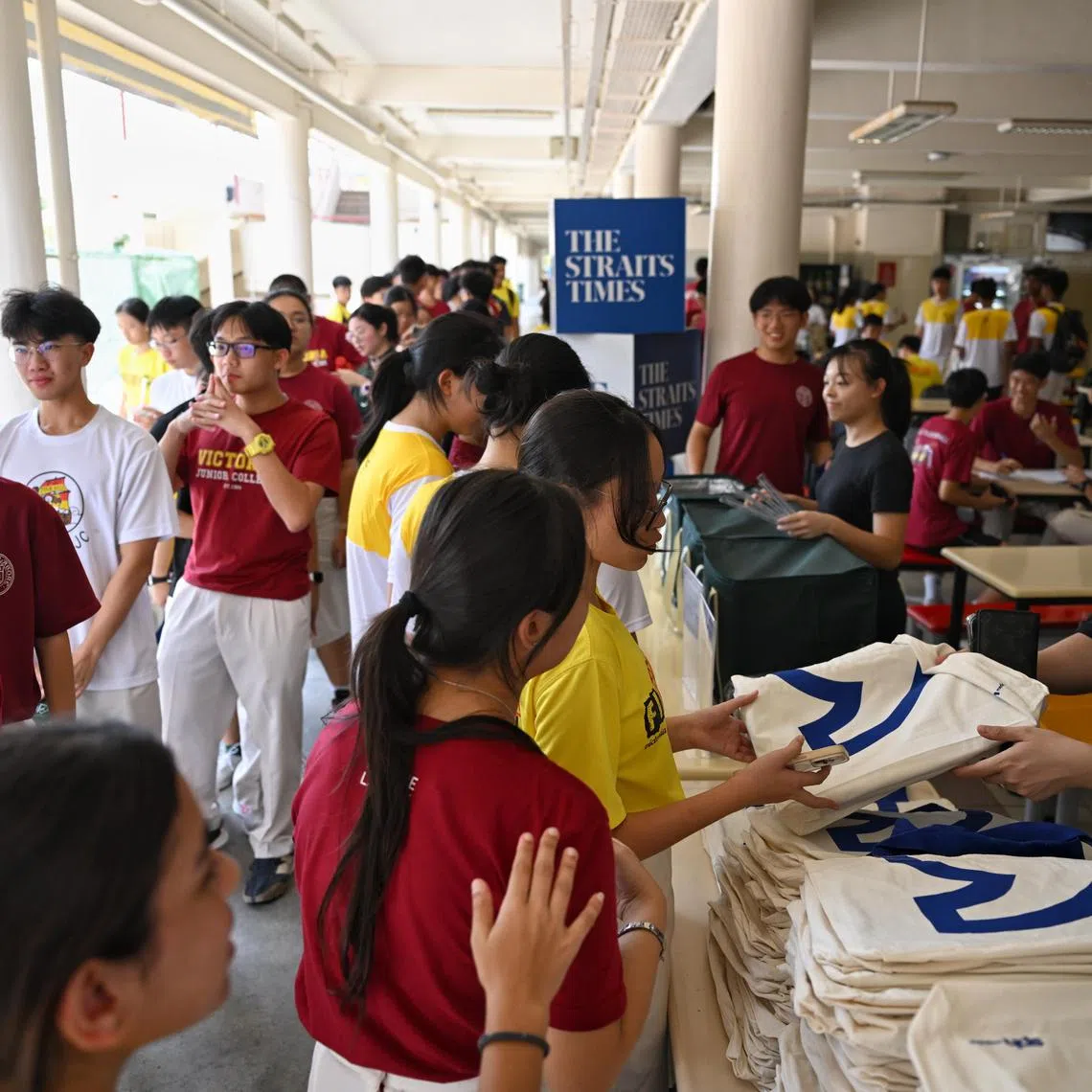 Students collecting a goodie bag containing a copy of The Straits Times and the ST Scholar?s Choice supplement at Victoria Junior College on Feb 21, 2025.