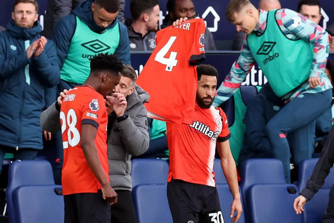 Luton's Andros Townsend celebrates his goal by holding aloft a shirt in support of team captain Tom Lockyer, who suffered a cardiac arrest on the pitch a week earlier against Bournemouth.