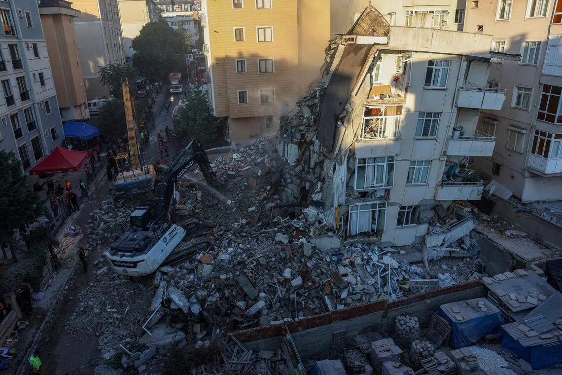 A partially collapsed building is demolished in an effort to reach any remaining people believed to be trapped inside in Istanbul, Turkey, on Oct 8.
