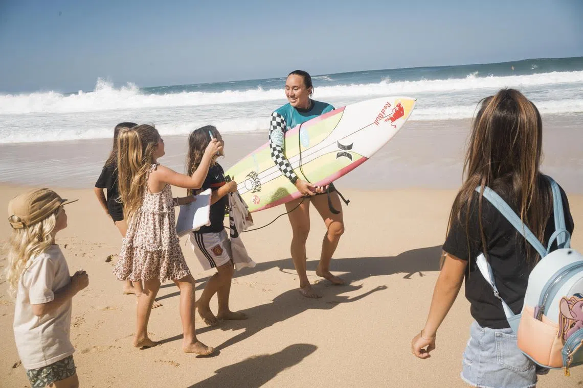 Olympic gold medallist and five-time world champion surfer Carissa Moore greeting fans on the beach during a competition on the North Shore of Oahu on Dec 17, 2022.