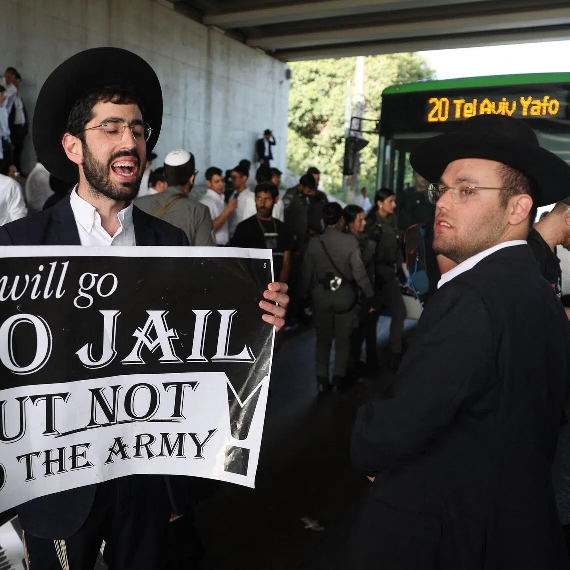 An Ultra-Orthodox Jew, who is largely exempt from military service, holds a placard while protesting with others against conscription near the centre of the Israeli city of Bnei Brak on April 28, 2026. 