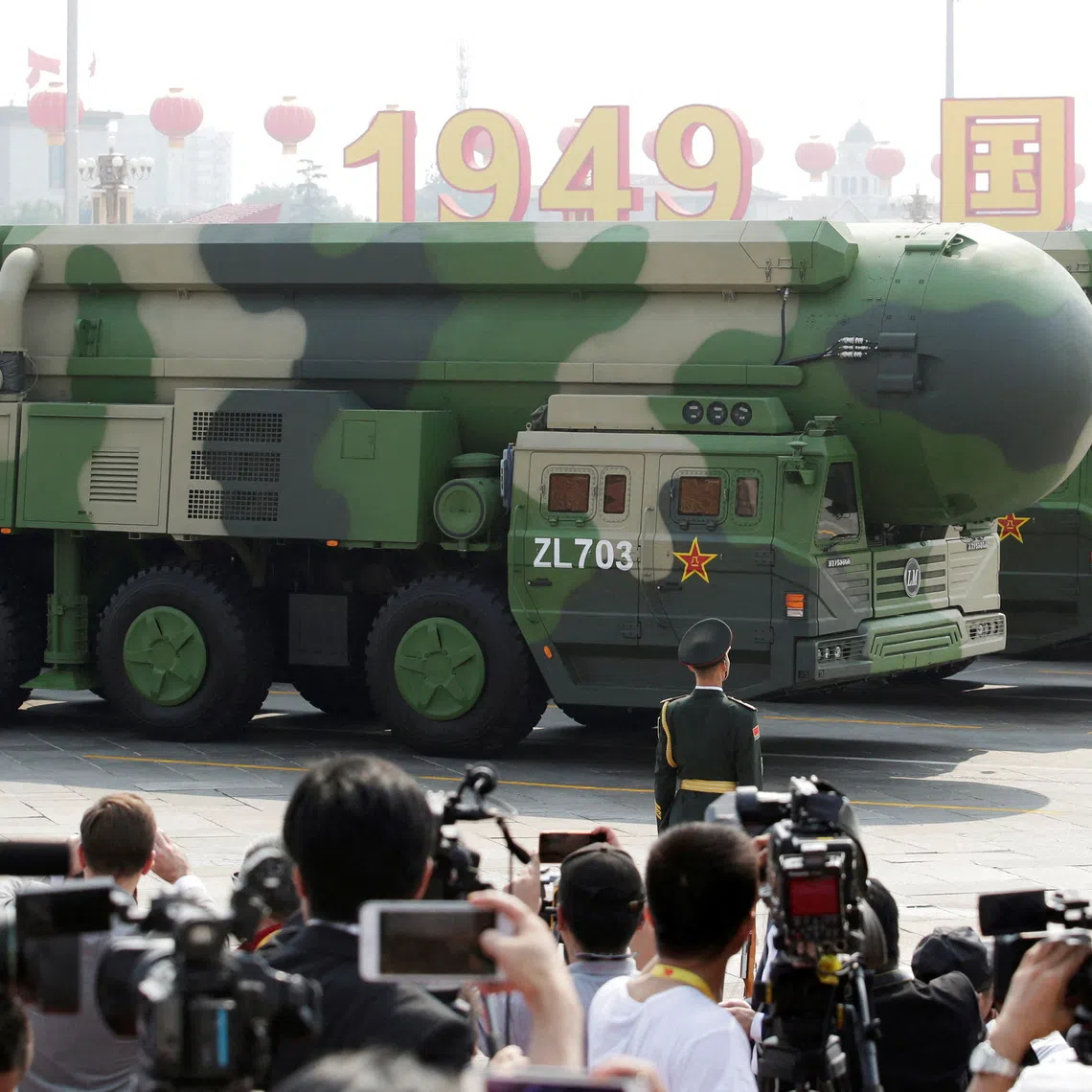 FILE PHOTO: Military vehicles carrying DF-41 intercontinental ballistic missiles travel past Tiananmen Square during the military parade marking the 70th founding anniversary of People's Republic of China, on its National Day in Beijing, China October 1, 2019. REUTERS/Jason Lee/File Photo