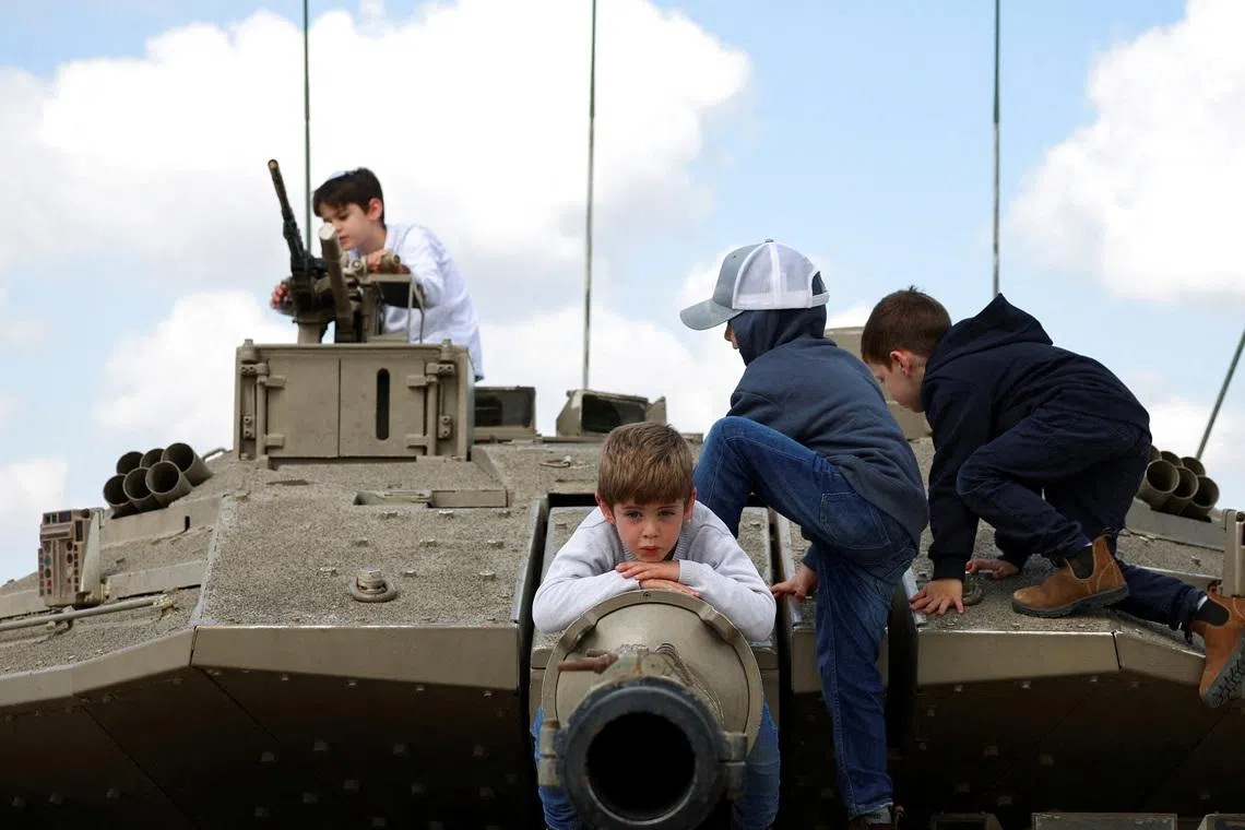 Children playing atop a tank, on Israel's Memorial Day, which commemorates fallen soldiers of Israel's wars and Israeli victims of hostile attacks, in Latrun, Israel, April 21.