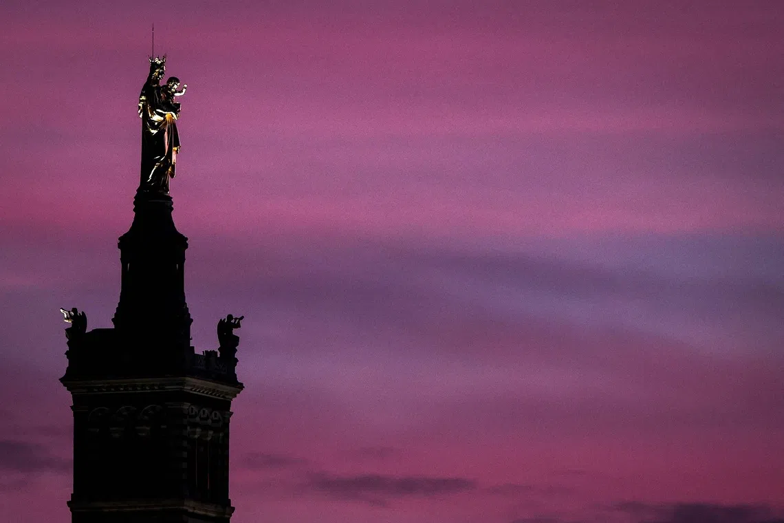 The newly restored statue of the Virgin Mary atop the Basilica of Notre-Dame de la Garde at sunset, in Marseille, southern France, on Dec 7, 2025. 