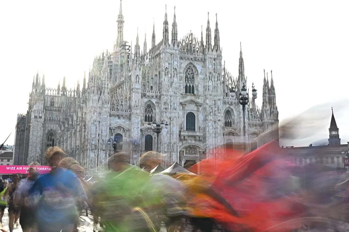 Athletes running at the start of Milan Marathon at Piazza Duomo in Italy on April 7, 2024. 