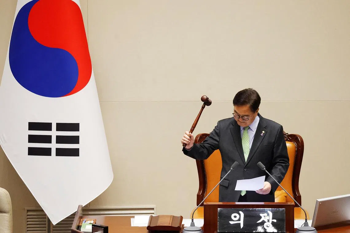South Korean National Assembly Speaker Woo Won-shik bangs the gavel to announce that "the voting cannot take place" because the quorum was not reached during a plenary session of the impeachment vote of President Yoon Suk Yeol at the National Assembly in Seoul, South Korea, 7 December, 2024. Yoon faces a motion brought by opposition lawmakers after declaring and then reversing martial law, citing the need to eliminate pro-North Korean forces and uphold the constitutional order. JEON HEON-KYUN/Pool via REUTERS