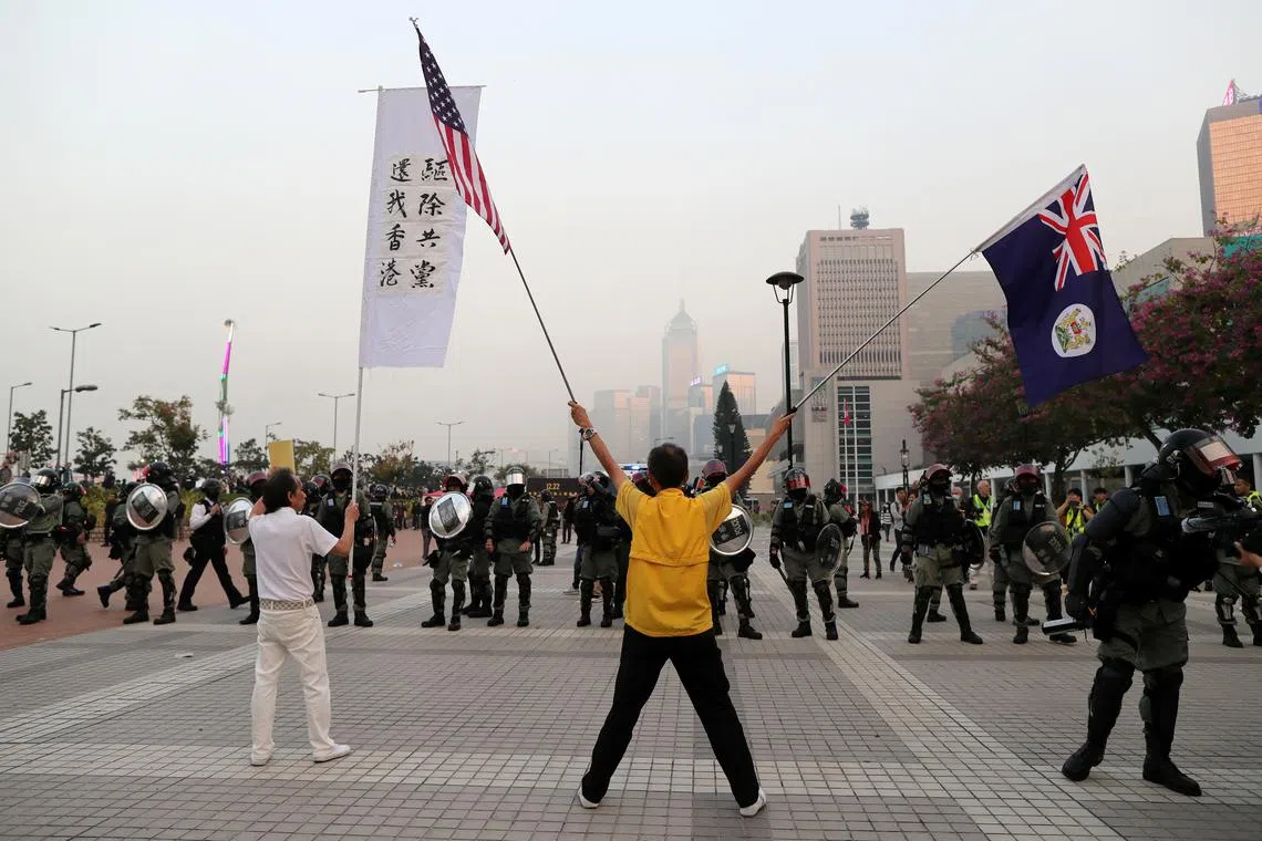FILE PHOTO: Hong Kong protesters face off against riot police at a rally in support of the human rights of Xinjiang Uighurs in Hong Kong, China, December 22, 2019. REUTERS/Lucy Nicholson/File Photo