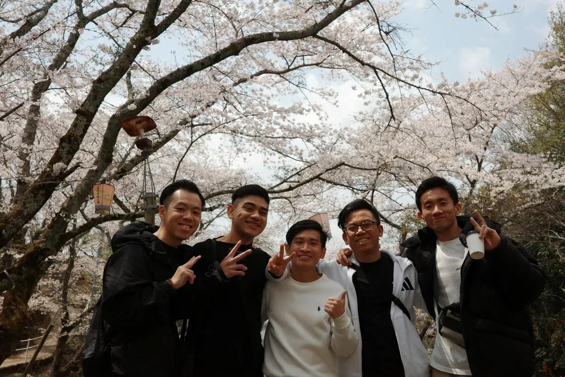 leroy lee (centre) manager and senior engineer at micron technology standing with colleagues during 18-month posting in hiroshima japan he went for three years after joining the company in 2021; micron ranked among best employers 2026 in singapore 