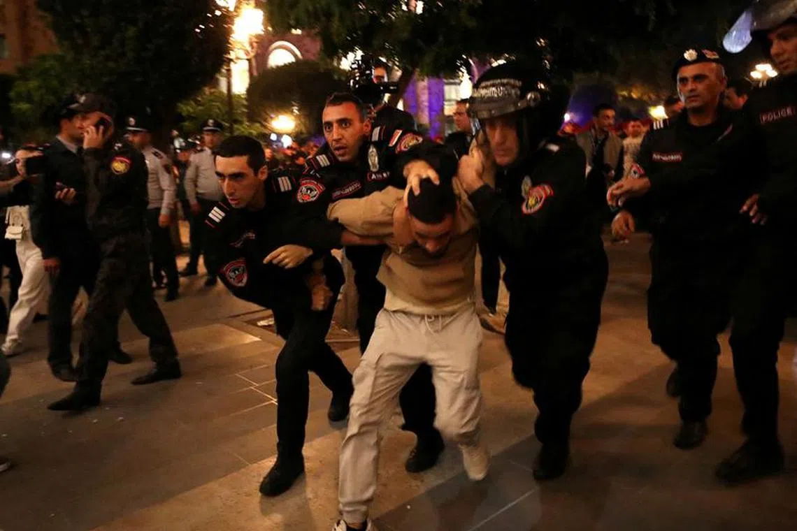 Law enforcement officers detain a protester near the government building during a rally to demand the resignation of Armenian Prime Minister Nikol Pashinyan following Nagorno-Karabakh surrender, in Yerevan, Armenia, September 21, 2023. Hayk Baghdasaryan/Photolure via REUTERS/File photo