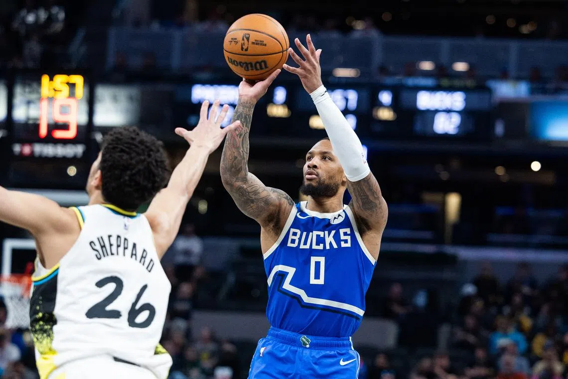 Milwaukee Bucks guard Damian Lillard (0) shoots the ball while Indiana Pacers guard Ben Sheppard (26) defends on March 11.
