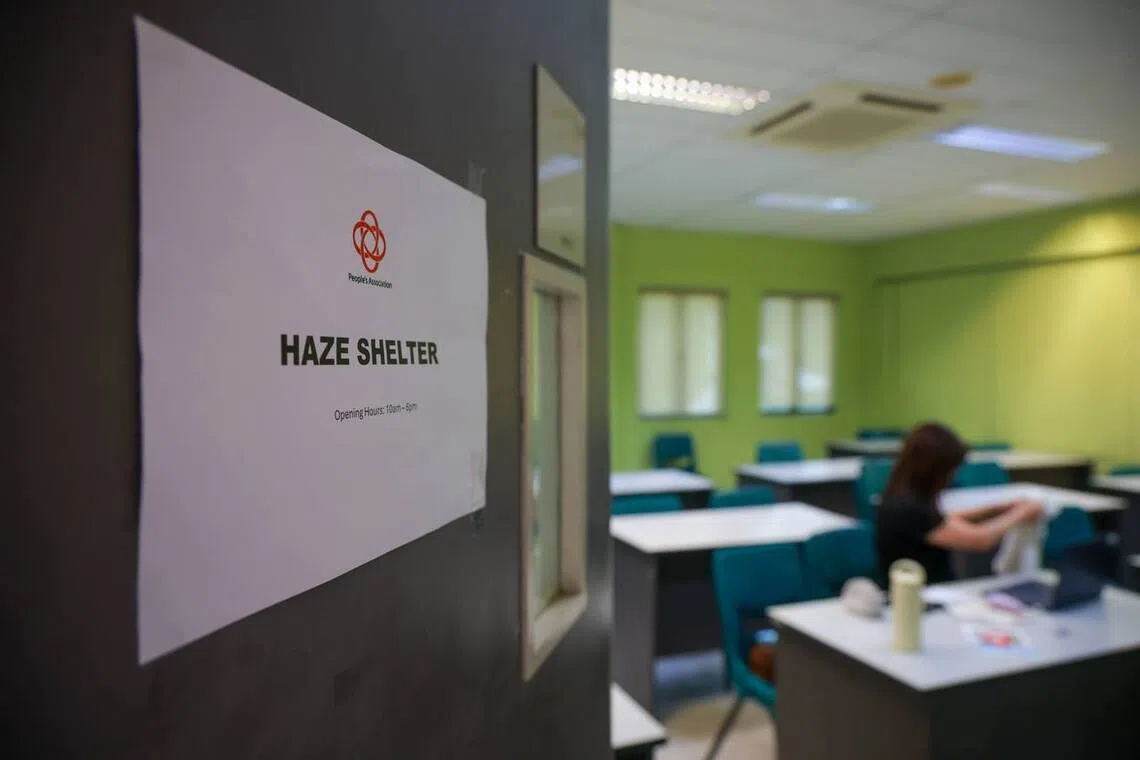 People’s Association staff working in the haze shelter at Kallang CC on Oct 15.
