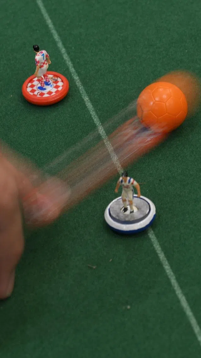 People play Subbuteo, a classic tabletop football game, at a community centre on June 18, 2026.