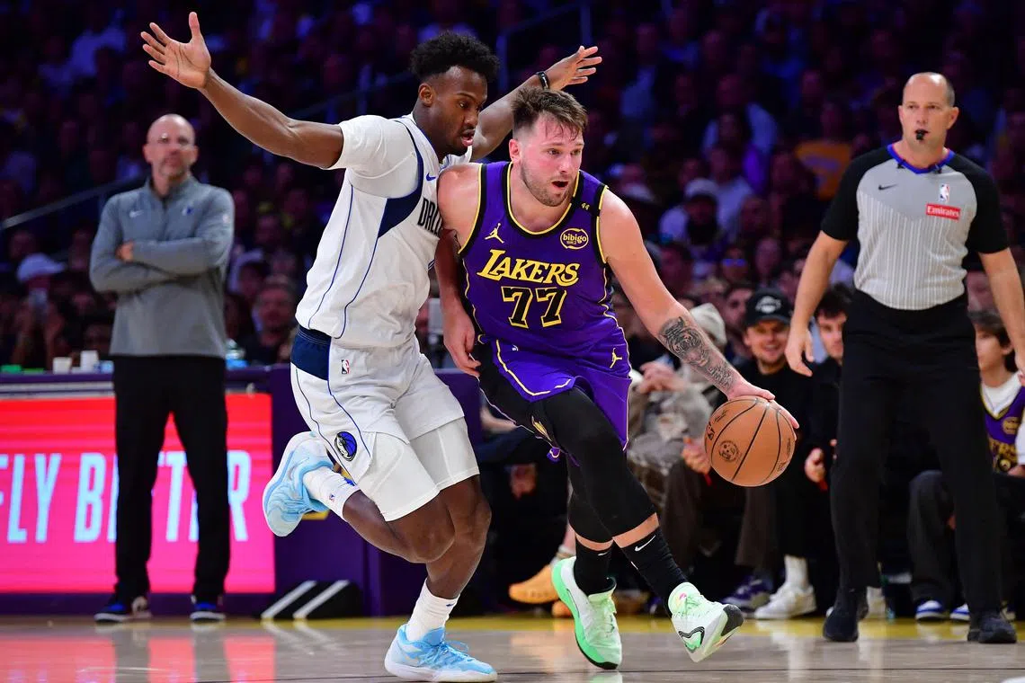 Los Angeles Lakers guard Luka Doncic dribbles the ball past Dallas Mavericks forward Olivier-Maxence Prosper during the second half at Crypto.com Arena. 