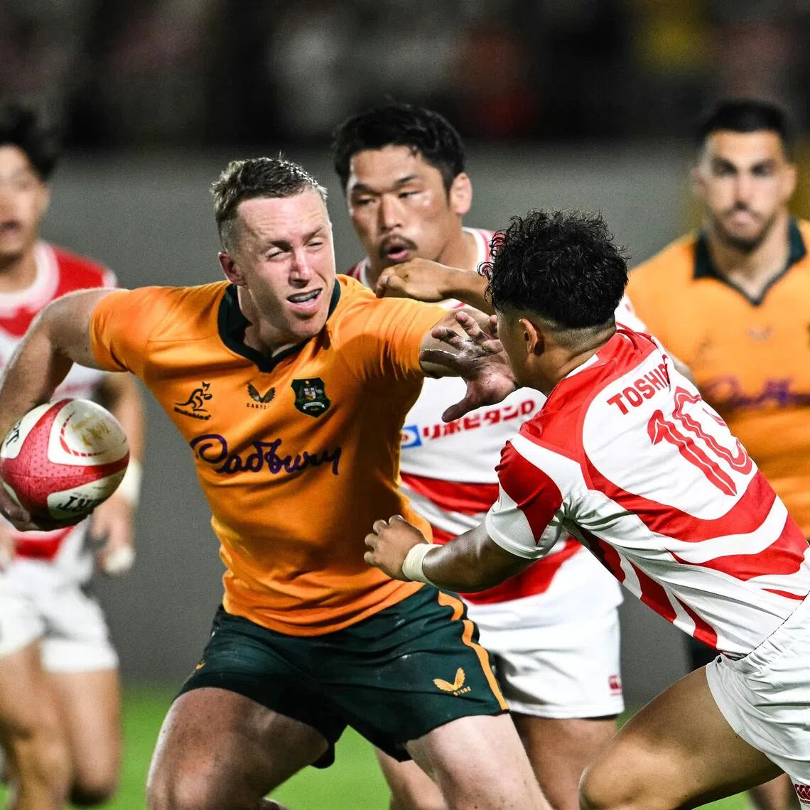 Australia's Harry Potter (C) runs with the ball during the Lipovitan D Challenge Cup rugby union Test match against Japan at Hanazono Rugby Stadium in Higashiosaka, Osaka prefecture, on August 8, 2026. (Photo by Philip FONG / AFP)