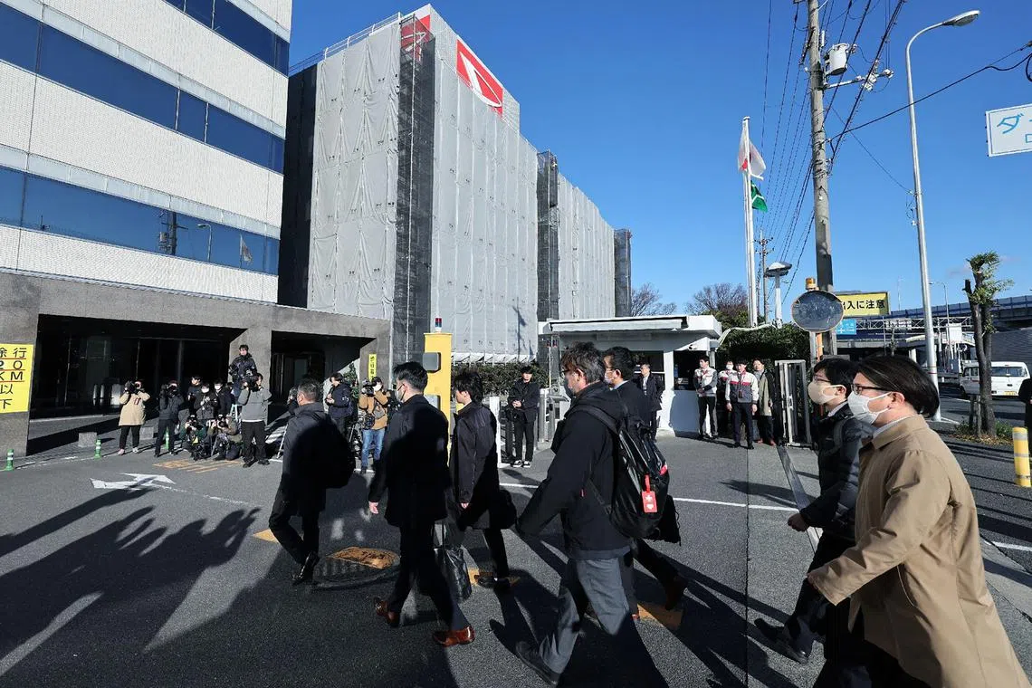 Officials from Japan's Ministry of Land, Infrastructure, Transport and Tourism enter the Daihatsu Motor headquarters for inspection work in Ikeda, on Dec 21.