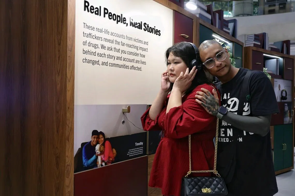 Former drug abuser Timothy York James and his wife Eleanore Lim listen to their story during the Drug Victims Remembrance Day observance at Suntec City Atrium on May 15, 2026. 