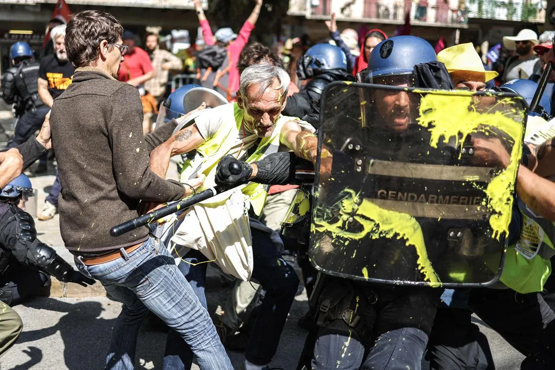 Protesters clashing with French gendarmes during a demonstration against the pension reform on the sidelines of the 25th Conference of the Small Towns in Millau, southern France, on June 1, 2023. 