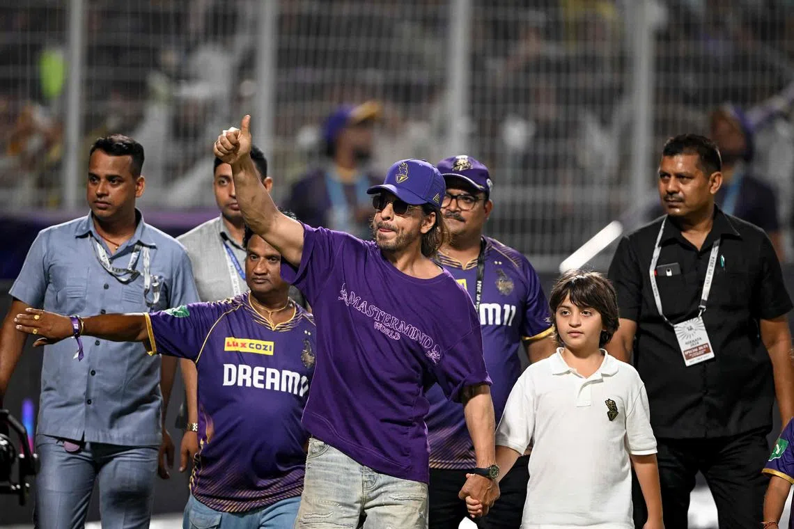 Shah Rukh Khan, Bollywood actor and co-owner of Kolkata Knight Riders, and son Abram Khan greeting fans after their Indian Premier League win over Delhi Capitals at Eden Gardens on April 29, 2024.