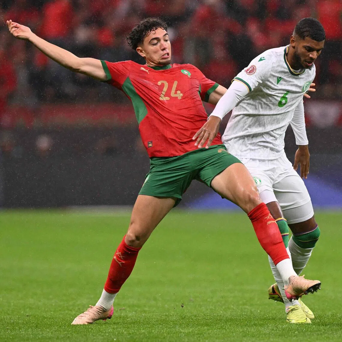 Morocco midfielder Neil El Aynaoui (left) fighting for the ball with Comoros midfielder Iyad Mohamed during Morocco's 2-1 win in their Africa Cup of Nations Group A football match at Prince Moulay Abdellah Stadium in Rabat on Dec 21, 2025.