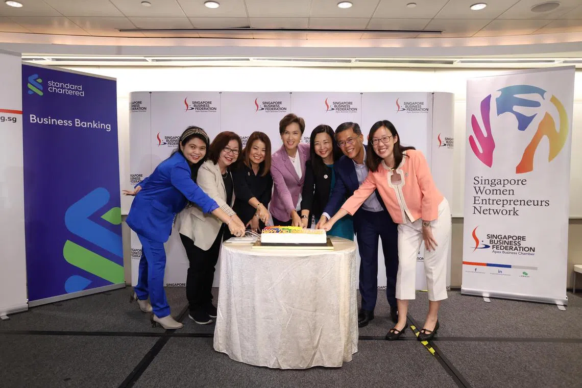 jswomen21 - The Singapore Women Entrepreneurs Network (SG-WEN), a network established by the Singapore Business Federation (SBF), commemorated its second anniversary at the NTUC Business Centre on Sept 20. Minister for Communications and Information Josephine Teo (centre) cut a cake with SG-WEN chairperson Rachel Eng (third from right), Singapore Business Federation chief executive Kok Ping Soon (second from right) and SG-WEN exco members.



Credit: Singapore Business Federation