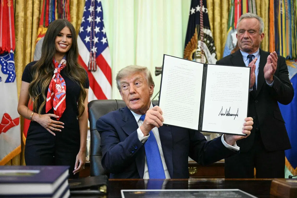 US President Donald Trump signs an executive order calling for more research and flexibility on vaccines.