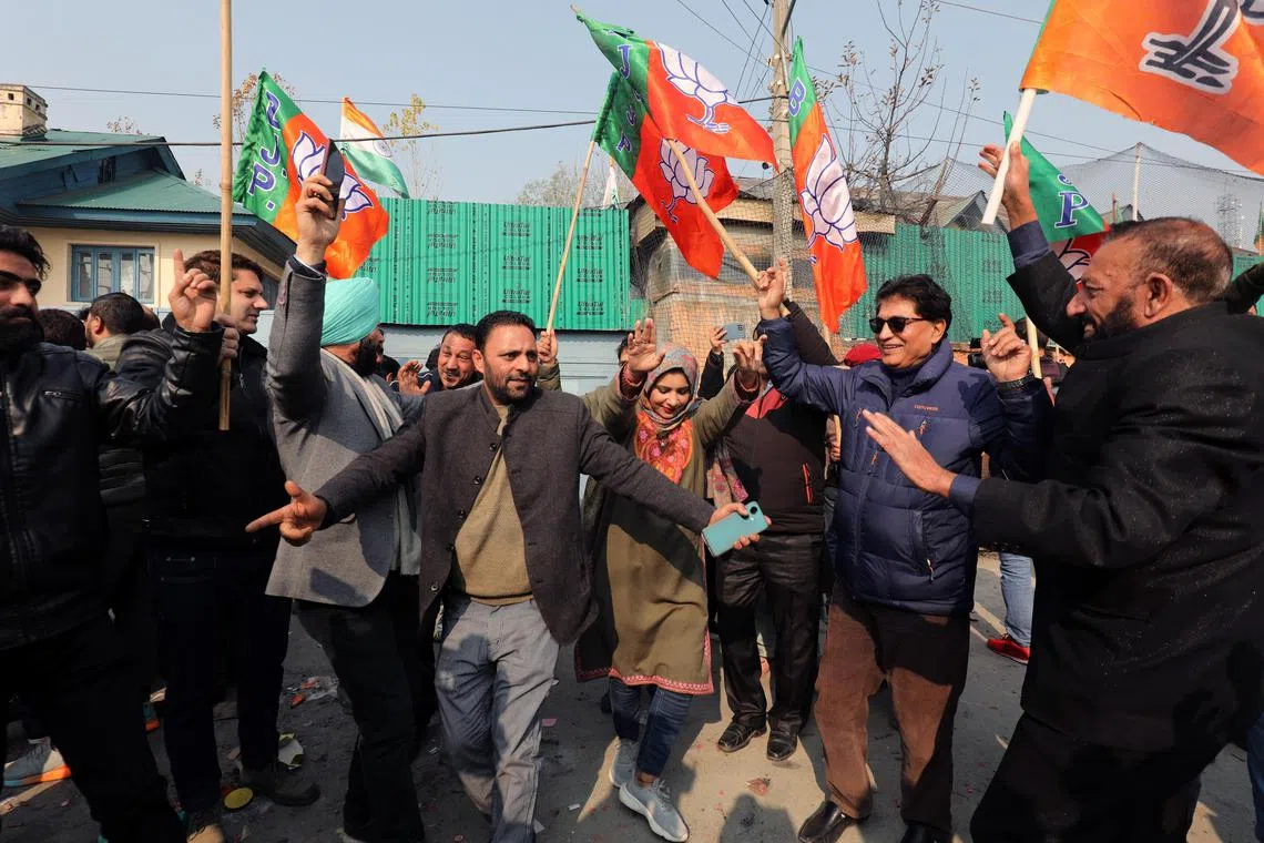 BJP supporters celebrate their victory in three out of four regional assembly elections, in Srinagar.
