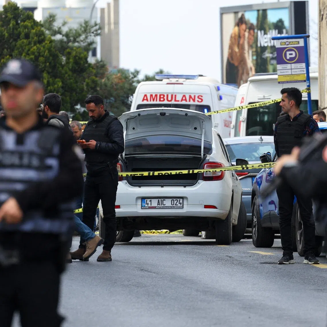 Police officers search a car at the scene, after gunfire was heard near the building housing the Israeli consulate, according to a witness, in Istanbul, Turkey, April 7, 2026. REUTERS/Murad Sezer