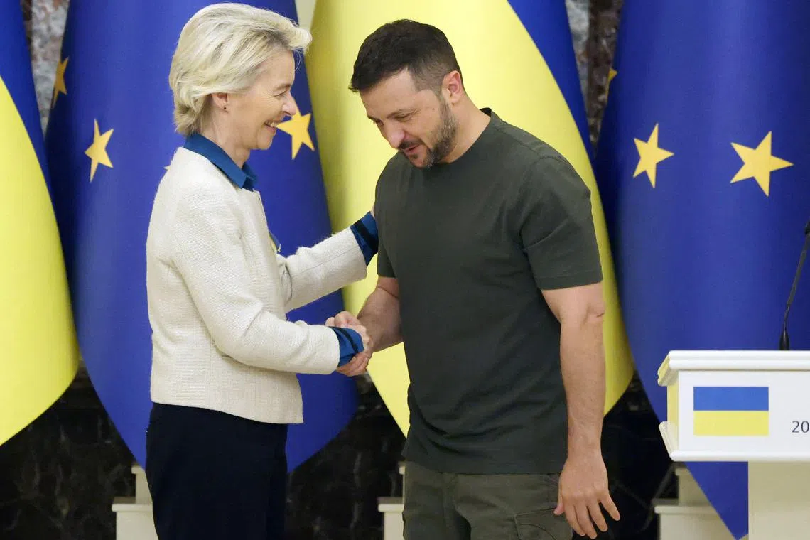 European Commission president Ursula von der Leyen (left) and Ukrainian President Volodymyr Zelensky shaking hands after a joint press conference in Kyiv, on Sept 20.