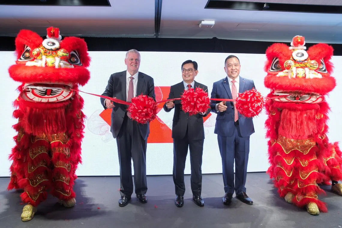 (From left) HSBC Group CEO Noel Quinn, DPM Heng Swee Keat and HSBC Singapore CEO Wong Kee Joo cutting the ribbon at the official opening of HSBC's new Singapore headquarters on Nov 14, 2022.