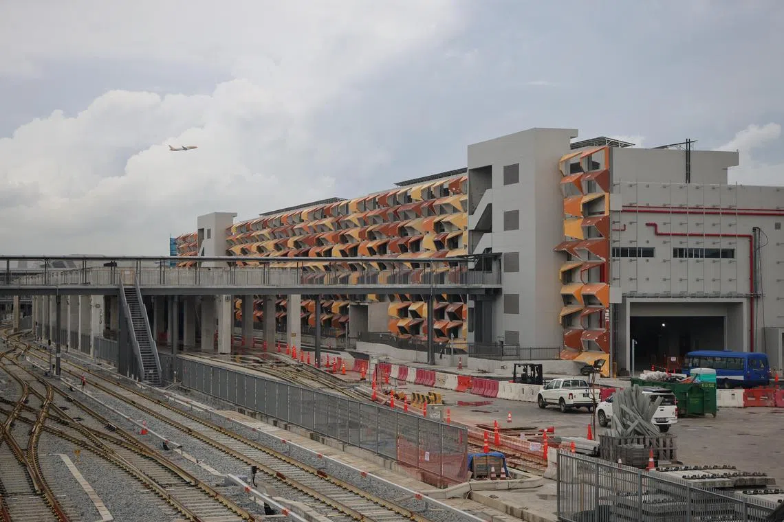 ST20241127_202478200197/pixecid/Jason Quah embargoed until 29 Nov 2024, Friday, at 6.00pm
A plane flies over the permanent way building of the East Coast Integrated Depot pictured during a media site visit on Nov 27, 2024. ST PHOTO: JASON QUAH