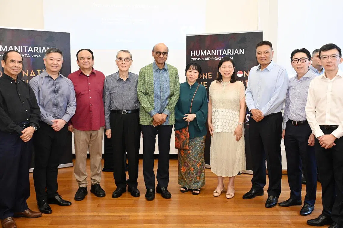 President Tharman Shanmugaratnam (fifth from left) and his spouse, Ms Jane Ittogi (fifth from right), with veteran diplomat and Humanity Matters chairman Ong Keng Yong (fourth from left) and representatives from the Chinese, Indian, and Malay chambers of commerce, and several philanthropists and corporate leaders on March 10.