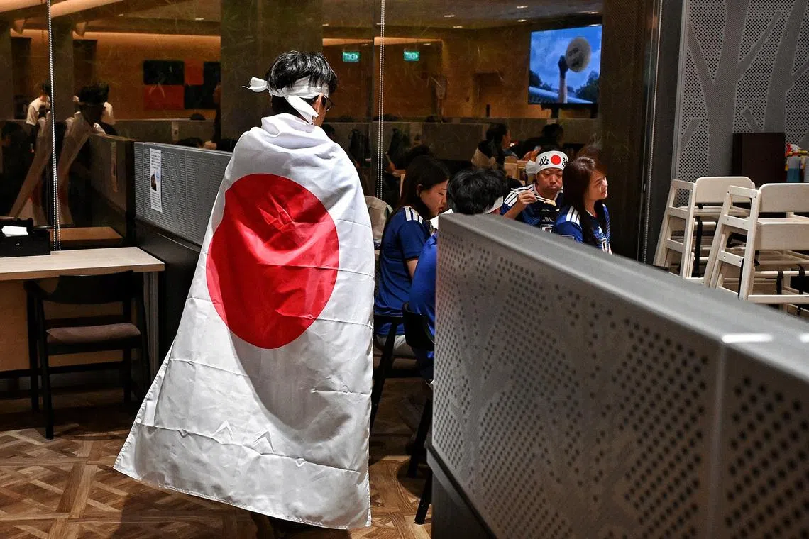 ST20260630_202652400543 Kua Chee Siong/ pixscreens/  (Pls note: For pixdesk HIF, only used for that purpose) A fan of the Japanese football team draped in the national flag, walking back to his seat during halftime at a watch party held at The Japanese Association, on June 30, for the World Cup game against Brazil. Screens are a defining feature of modern life, often drawing our attention away from the world around us. Yet there are moments when screens do the opposite – when they bring people together and connect them to a shared reality. Few events demonstrate this more powerfully than football's World Cup. Whether gathered in crowded bars, public squares, living rooms, or streetside cafés, supporters fix their eyes on television screens not in isolation, but in collective anticipation. The beautiful game transcends borders, languages, and cultures, turning millions of individual viewers into a global community united by hope, pride, and passion. As the world looks ahead to the 2026 FIFA World Cup, screens will once again become windows onto a shared human experience, carrying the drama, joy, heartbreak, and celebration of the tournament to fans across every corner of the globe. In those moments, technology ceases to divide attention and instead becomes a conduit for connection, transforming spectators into participants in one of the world's greatest sporting spectacles.