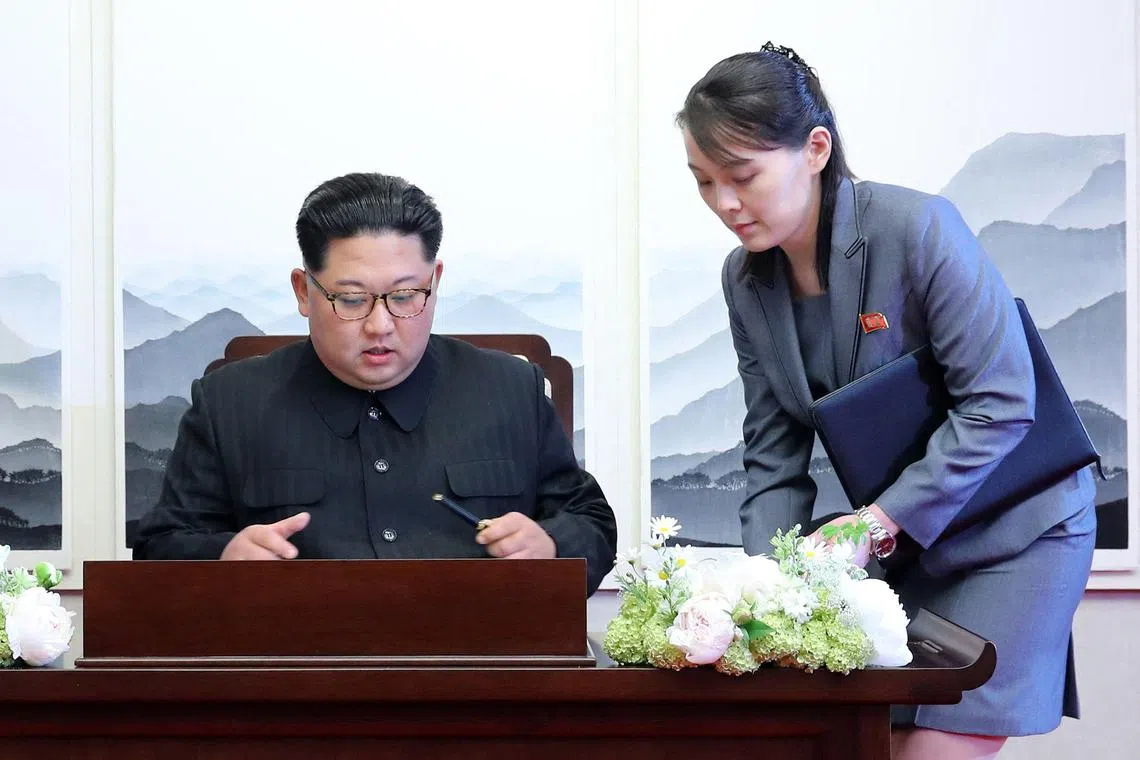 (FILES) North Korea's leader Kim Jong Un (L) signs the guest book next to his sister Kim Yo Jong (R) during the Inter-Korean summit with South Korea's President Moon Jae-in (not pictured) at the Peace House building on the southern side of the truce village of Panmunjom on April 27, 2018. The powerful sister of North Korean leader Kim Jong Un slammed Seoul on July 8, 2024 for recent military drills near the border, saying the South must be "suicidal" and warning of a "terrible disaster". (Photo by Korea Summit Press Pool / Korea Summit Press Pool / AFP)