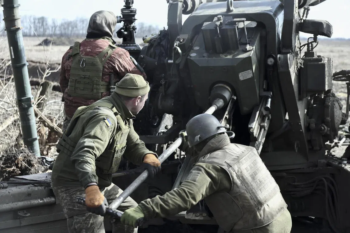 Ukrainian soldiers prepare to fire a howitzer from their position in the Zaporizhzhia area of Ukraine, on March 2, 2023.