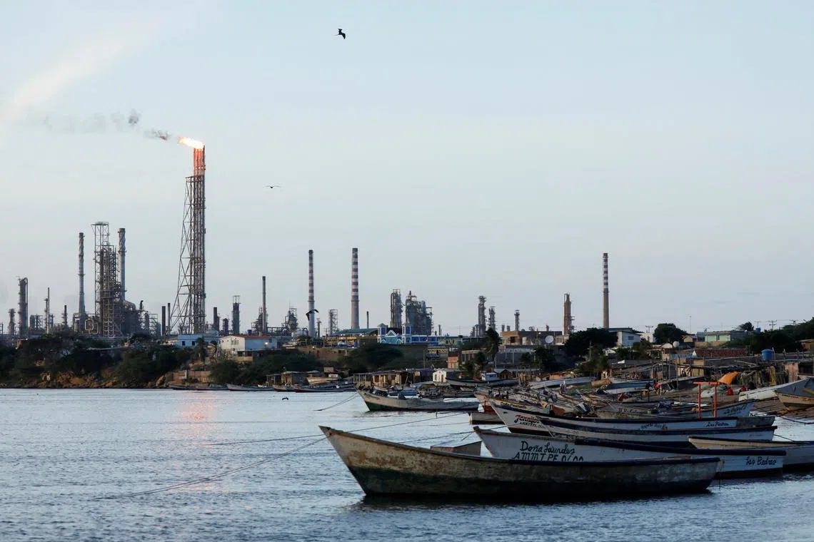 FILE PHOTO: Fishing boats are moored down the coast from the Paraguana Refining Center (CRP). Picture taken October 2, 2021. REUTERS/Leonardo Fernandez Viloria/File Photo